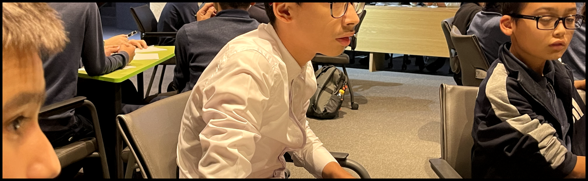 Students in a classroom setting, focused on their work