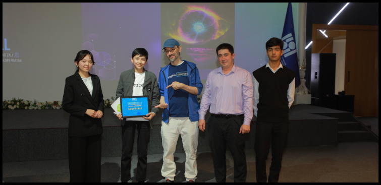 Small group receiving an award on stage, recognition event