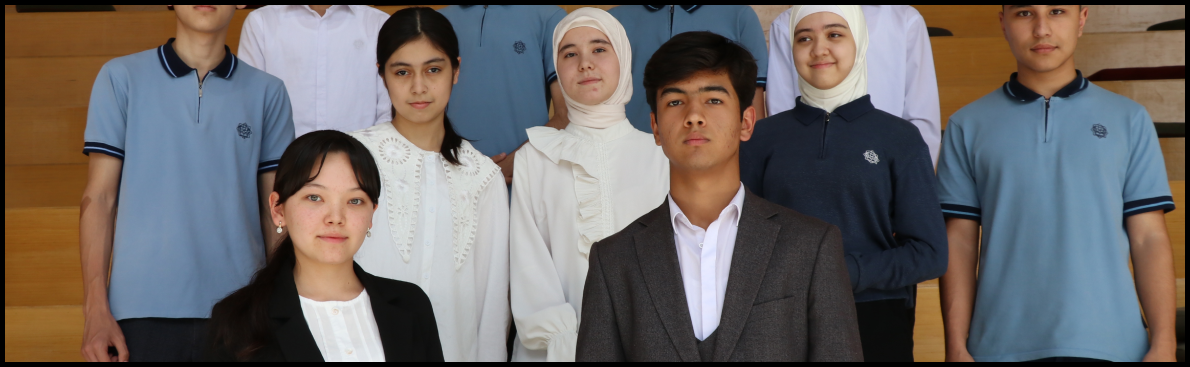 Diverse group of people posing for a photo, mix of formal and casual attire